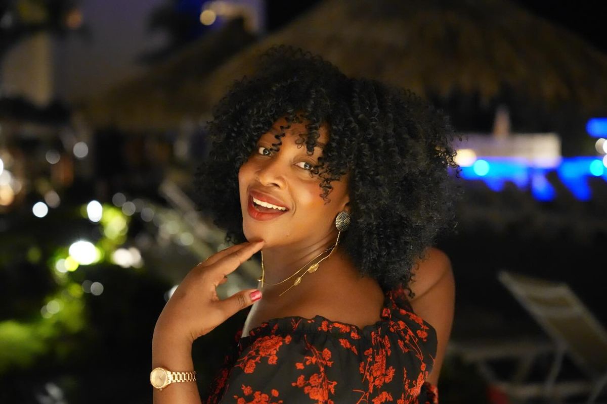 Woman with curly hair, night portrait outdoors