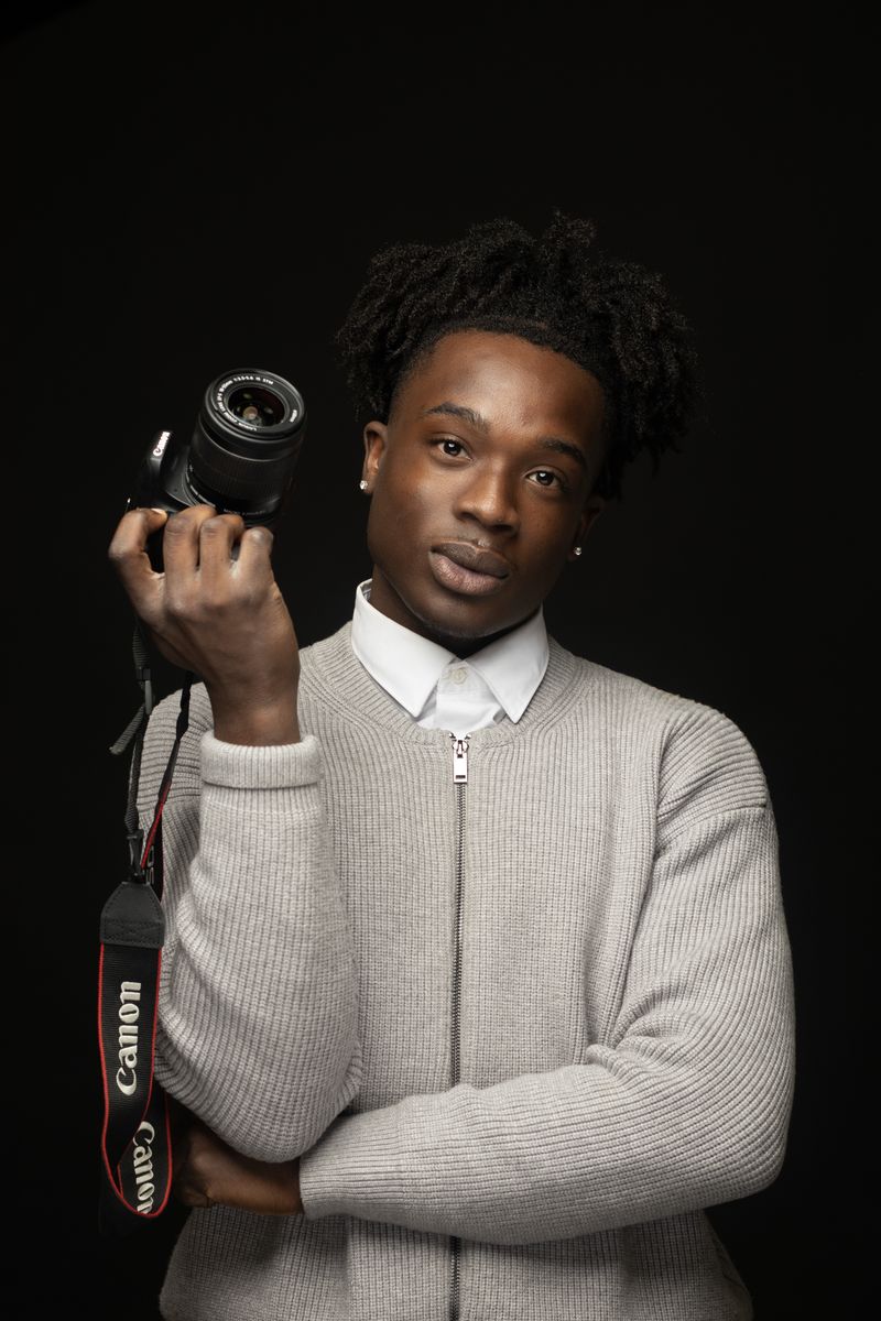 Young photographer holding his camera