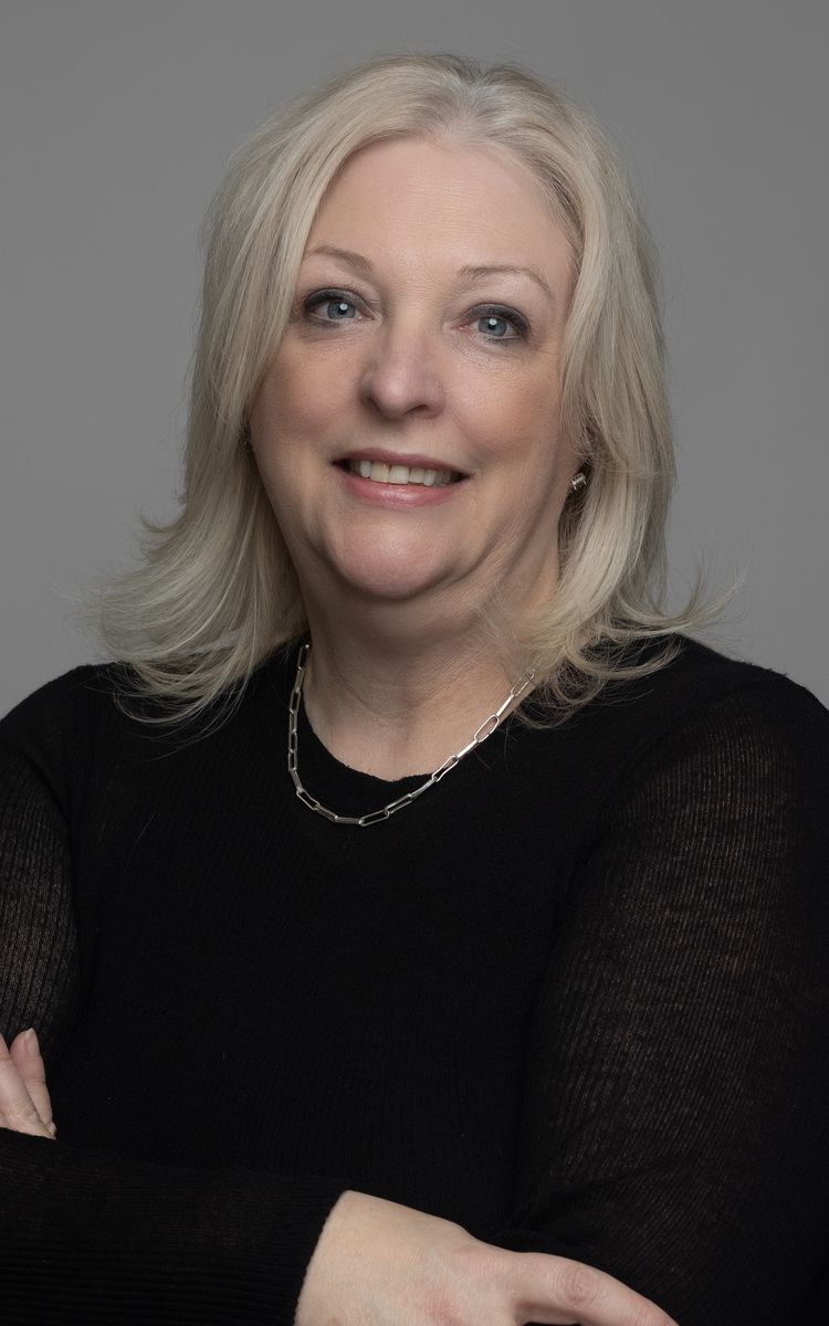 Professional headshot, woman in black