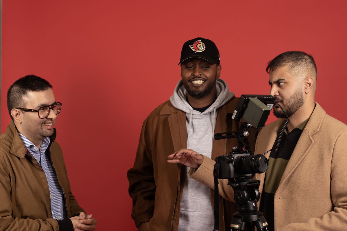Three-person video crew filming in the studio